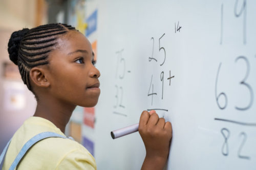 Girl solving mathematical addition Girl solving mathematical addition
